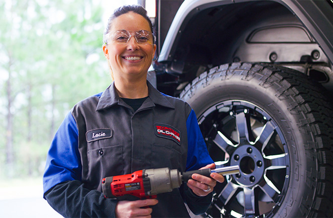 smiling technician holding impact wrench